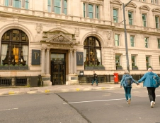 A couple crossing the road to the hotel