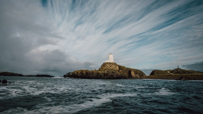 lighthouse on a rock in the sea.
