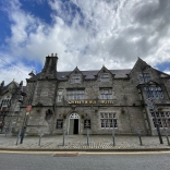 Exterior of an old stone pub.