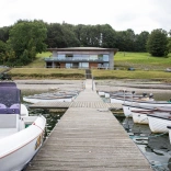 boats and jetty, with visitor centre in background.